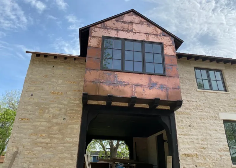 Copper metal panel facade on a stone building for Roof Repair in Fort Myers Beach